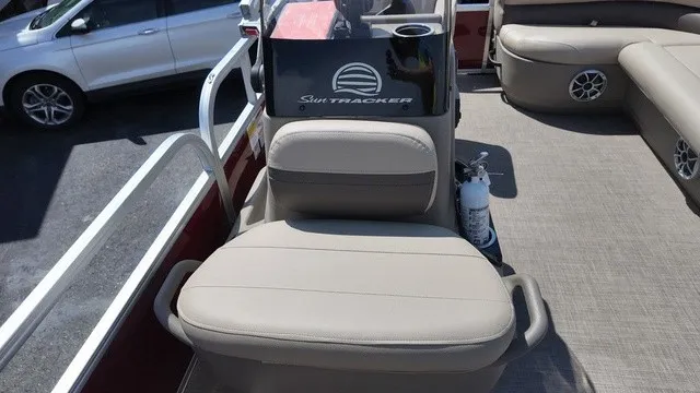 Slide: The Image of The image shows the cockpit of a 2025 Sun Tracker Bass Buggy 16 XL Select with beige seating. - 24
