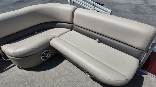 Slide: The Image of The 2025 Sun Tracker Bass Buggy 16 XL Select features a comfortable, beige upholstered seating area. - 17