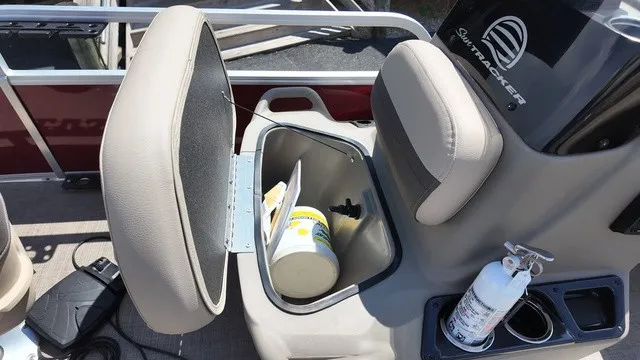Slide: The Image of An open storage compartment on a Sun Tracker Bass Buggy 16 XL Select boat with a fire extinguisher nearby. - 23