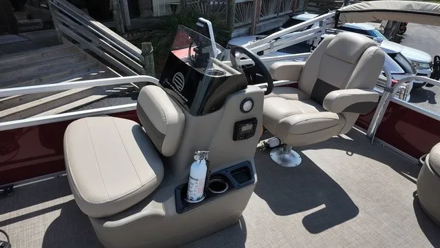 Slide: The Image of The image shows the cockpit of a 2025 Sun Tracker Bass Buggy 16 XL Select with beige seats. - 13