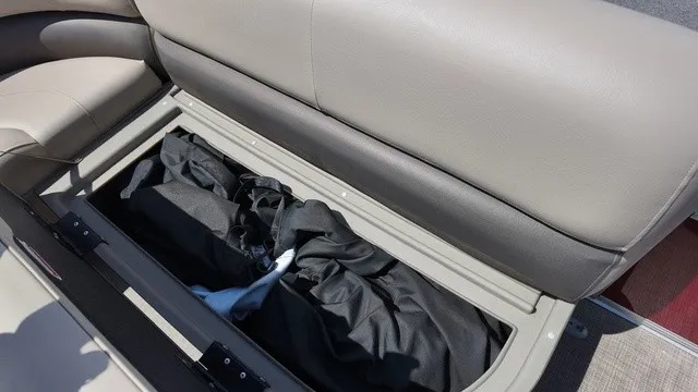 Slide: The Image of Bench seat with storage underneath, filled with black covers. - 18