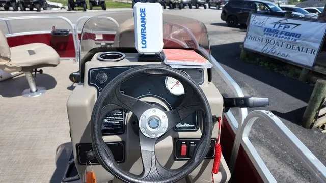 Slide: The Image of The image shows the helm of a Sun Tracker Bass Buggy 16 XL Select with a Lowrance device. - 15