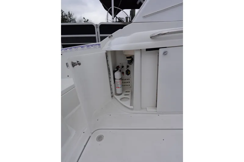 Slide: The Image of Open storage compartment on Formula 280 Sun Sport boat, featuring a fire extinguisher. - 37