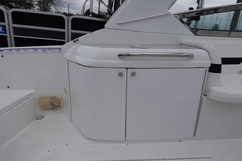 Slide: The Image of Interior view of a Formula 280 Sun Sport boat, featuring sleek white cabinetry and seating. - 36
