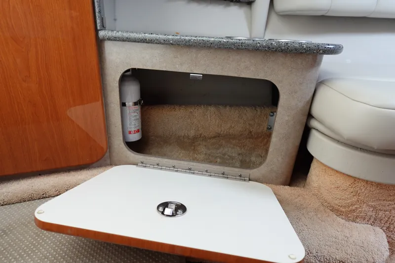 Slide: The Image of Interior storage compartment of 2005 Formula 280 Sun Sport boat with fire extinguisher. - 53