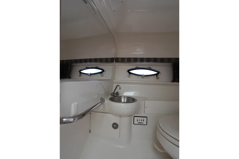 Slide: The Image of Interior of 2005 Formula 280 Sun Sport boat bathroom with sink and portholes. - 61