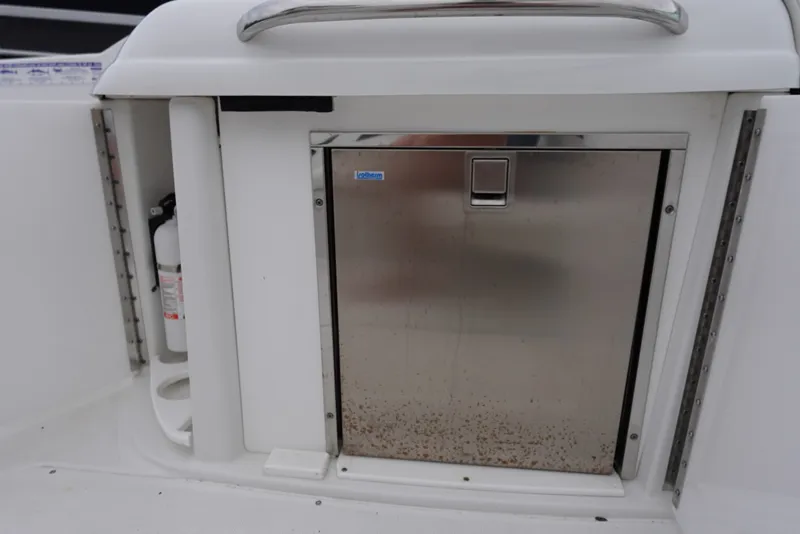 Slide: The Image of Stainless steel compartment on Formula 280 Sun Sport boat with fire extinguisher nearby. - 39