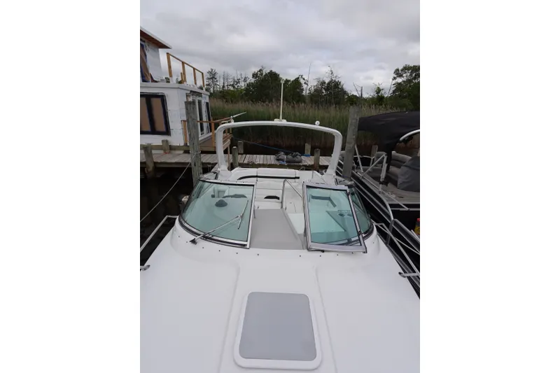 Slide: The Image of Formula 280 Sun Sport boat docked, featuring sleek design and spacious deck area. - 18