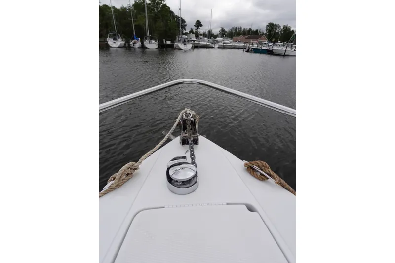 Slide: The Image of Bow view of Formula 280 Sun Sport boat in a marina, surrounded by other vessels. - 16