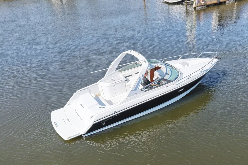 Slide: The Image of A white sport boat with a black hull floats on calm water. It has a sleek design. - 11