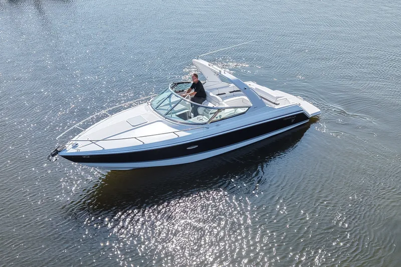 Slide: The Image of A white motorboat cruising on calm water. It features a blue stripe design and an open cabin. - 4