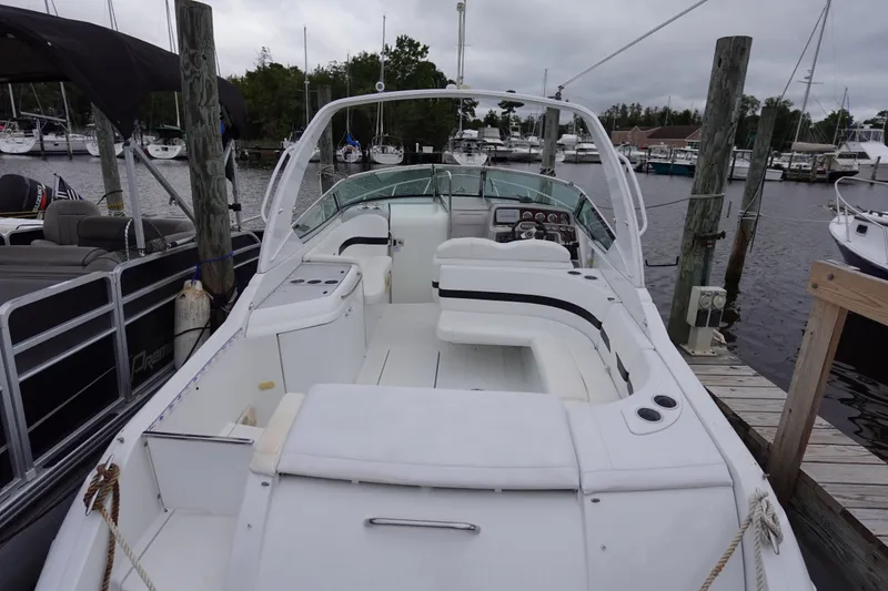 Slide: The Image of Formula 280 Sun Sport boat docked at marina, featuring spacious seating and sleek design. - 44