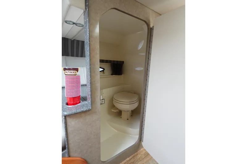 Slide: The Image of Interior of 2005 Formula 280 Sun Sport boat featuring compact bathroom with toilet. - 59