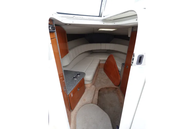Slide: The Image of Interior of Formula 280 Sun Sport boat with white seating and wooden cabinetry. - 45