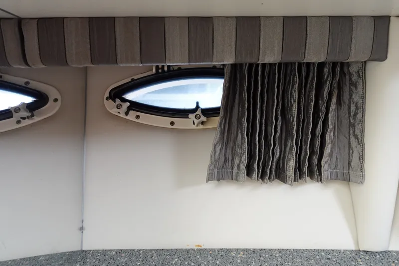 Slide: The Image of Interior view of 2005 Formula 280 Sun Sport boat with porthole and curtains. - 51