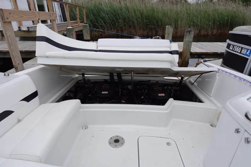 Slide: The Image of 2005 Formula 280 Sun Sport boat with open engine compartment, docked near reeds. - 62