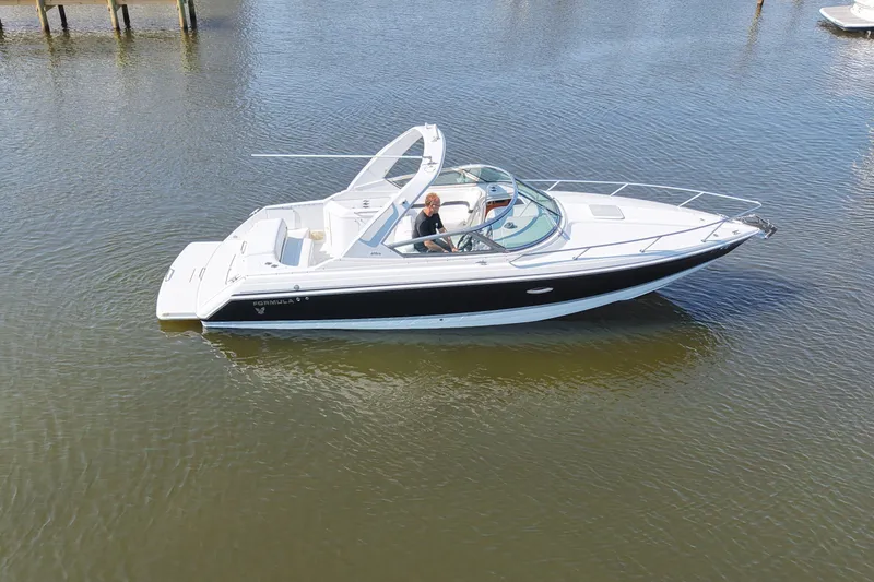 Slide: The Image of A white motorboat floating on calm water, featuring an open cockpit and sleek design. - 8