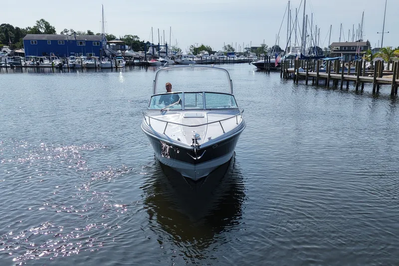 Slide: The Image of A 2005 Formula 280 Sun Sport cruising in a calm harbor with numerous sailboats. - 6