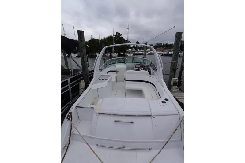 Slide: The Image of Formula 280 Sun Sport boat docked at marina, featuring spacious seating and sleek design. - 43