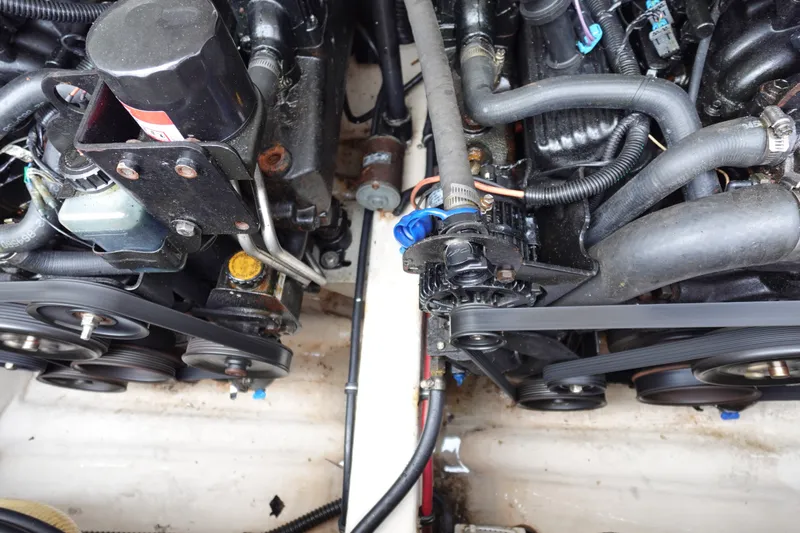 Slide: The Image of Engine components of a 2005 Formula 280 Sun Sport boat, featuring belts and hoses. - 69