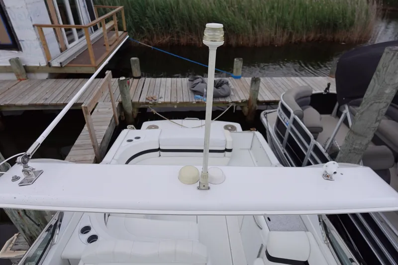 Slide: The Image of Formula 280 Sun Sport boat docked, featuring a white deck and seating area. - 19