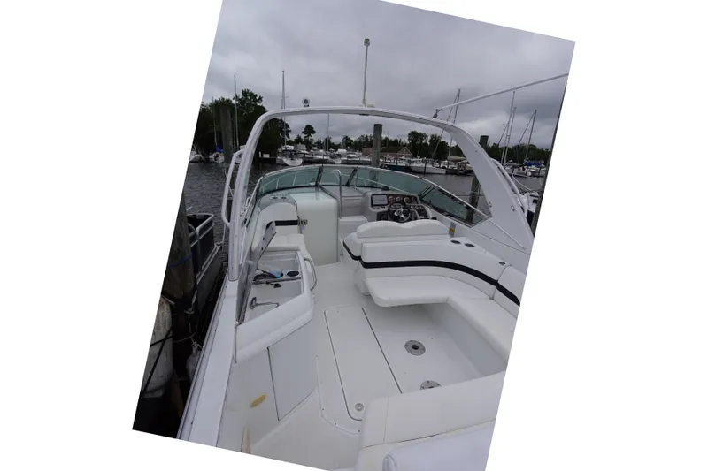 Slide: The Image of Formula 280 Sun Sport boat interior with seating and helm, docked at marina. - 28