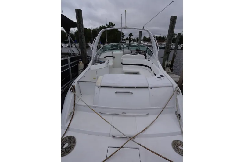 Slide: The Image of Formula 280 Sun Sport boat docked, showcasing spacious deck and seating area. - 42