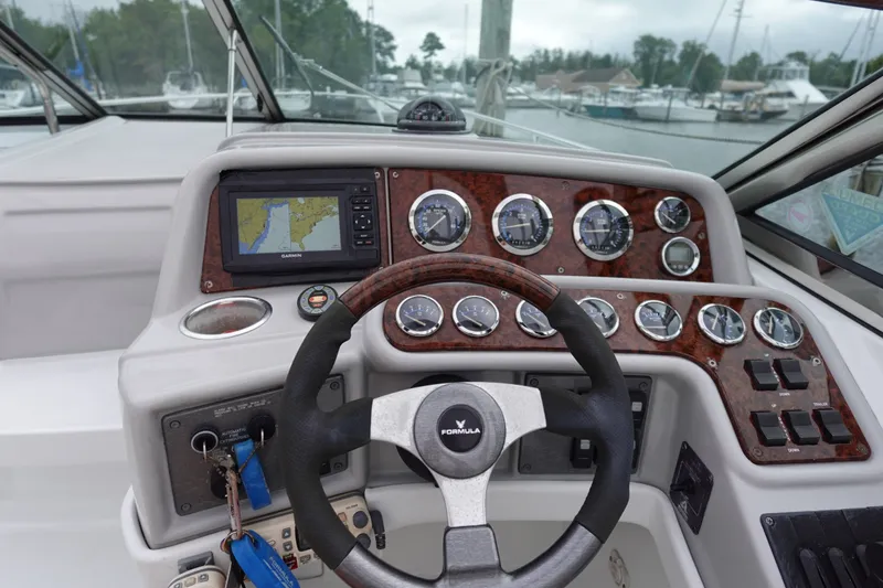 Slide: The Image of Cockpit of Formula 280 Sun Sport boat with steering wheel and navigation instruments. - 23