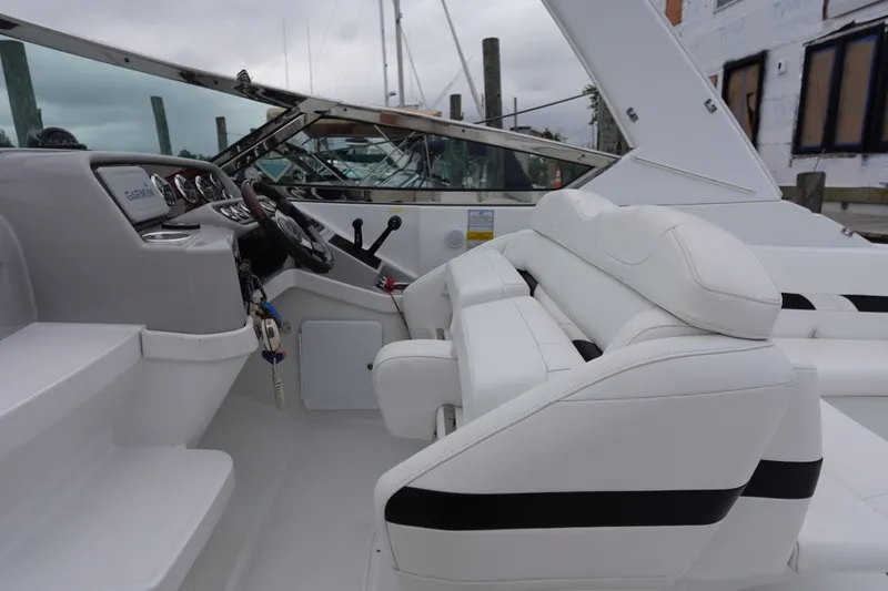 Slide: The Image of Interior view of a Formula 280 Sun Sport boat with white seating and control panel. - 24
