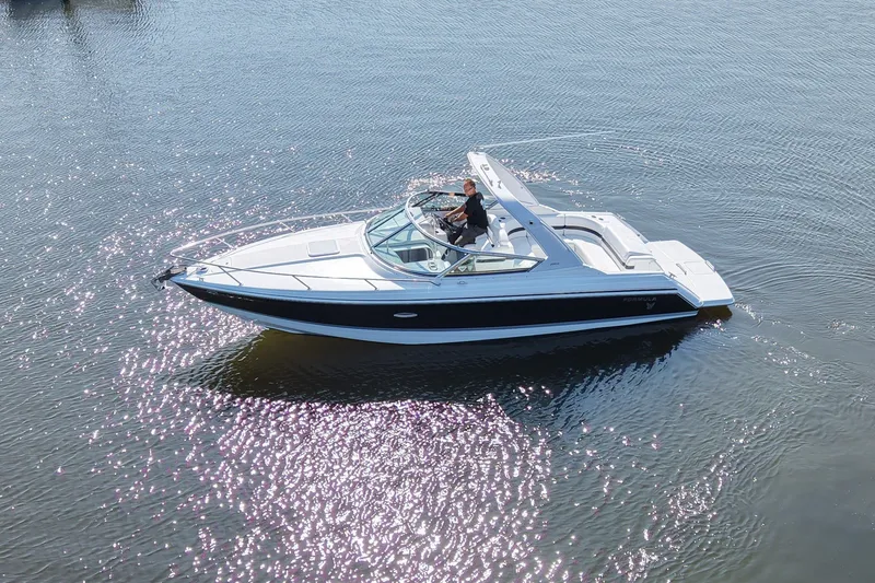 Slide: The Image of A white and blue motorboat cruising on calm water. It features an open cockpit and sun lounge. - 3