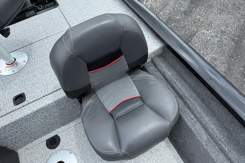 Slide: The Image of Gray seat on 2024 Tracker Pro Team 175 TF boat, featuring red accents and textured flooring. - 6