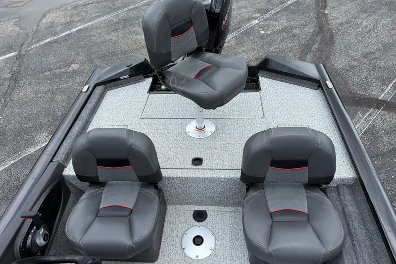 Slide: The Image of 2024 Tracker Pro Team 175 TF boat interior with four gray seats on a textured deck. - 4