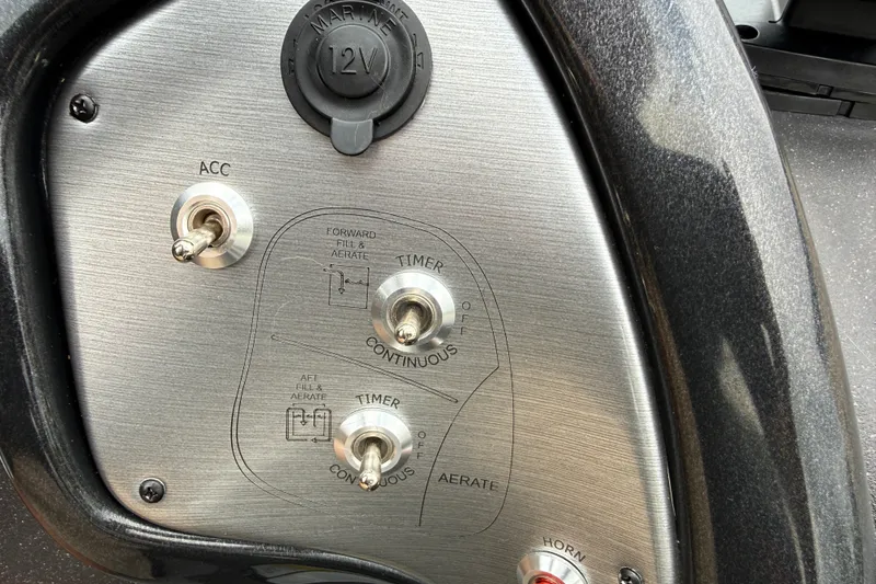 Slide: The Image of Control panel of 2024 Tracker Pro Team 175 TF boat with switches and 12V outlet. - 10