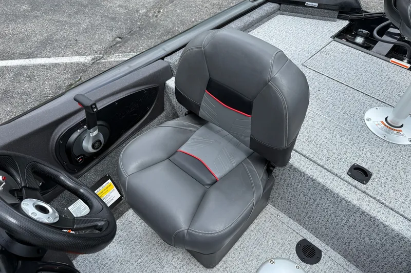 Slide: The Image of 2024 Tracker Pro Team 175 TF boat interior with gray seat and steering controls. - 5