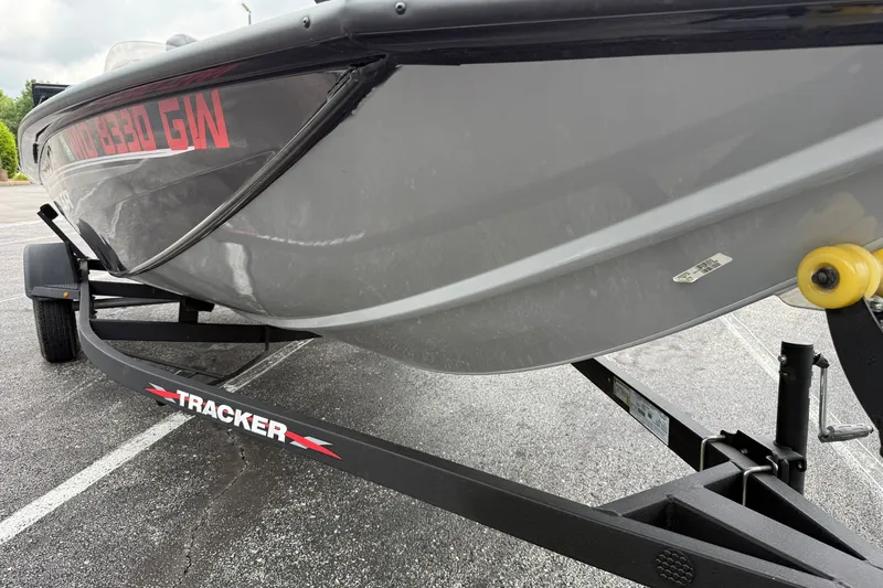 Slide: The Image of 2024 Tracker Pro Team 175 TF boat on trailer, parked in a lot. - 21