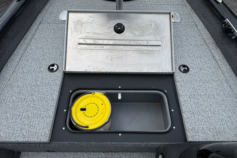 Slide: The Image of 2024 Tracker Pro Team 175 TF boat storage compartment with yellow bucket. - 13