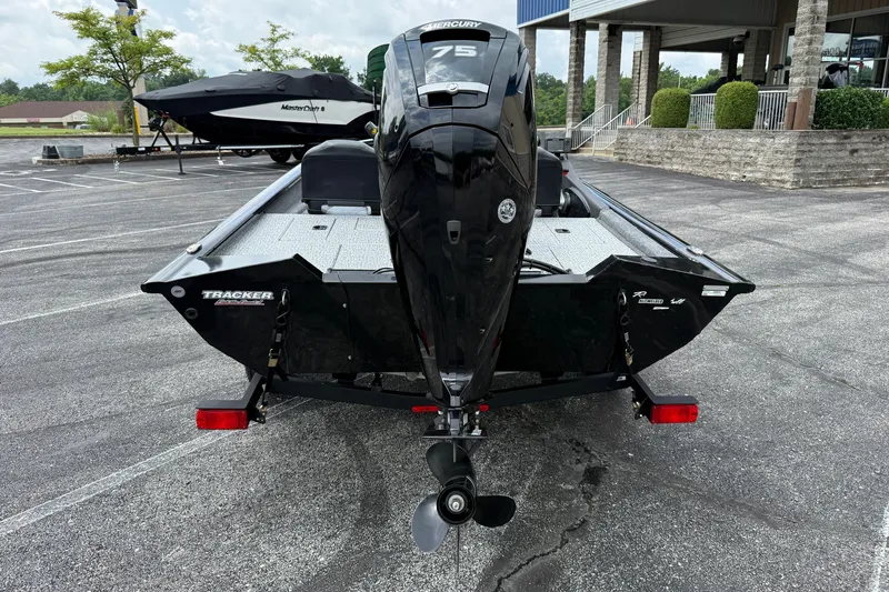 Slide: The Image of 2024 Tracker Pro Team 175 TF boat with Mercury 75 engine, parked outdoors. - 26