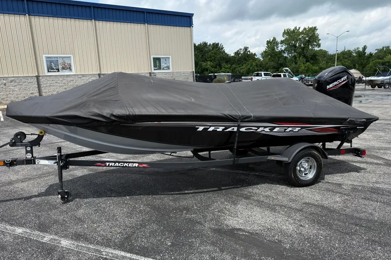 Slide: The Image of 2024 Tracker Pro Team 175 TF boat with cover on trailer in parking lot. - 30