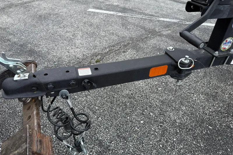 Slide: The Image of Trailer hitch of 2024 Tracker Pro Team 175 TF on asphalt surface. - 23
