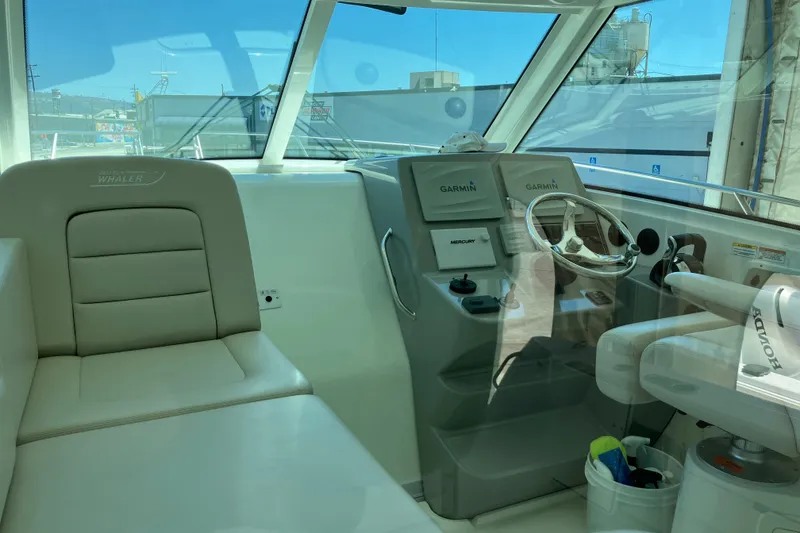 Slide: The Image of 2019 Boston Whaler 315 Conquest Pilothouse interior with Garmin navigation system. - 14