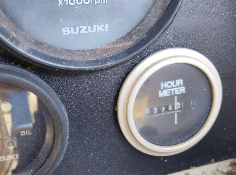 Slide: The Image of Close-up of an hour meter and a Suzuki tachometer on a boat. - 18