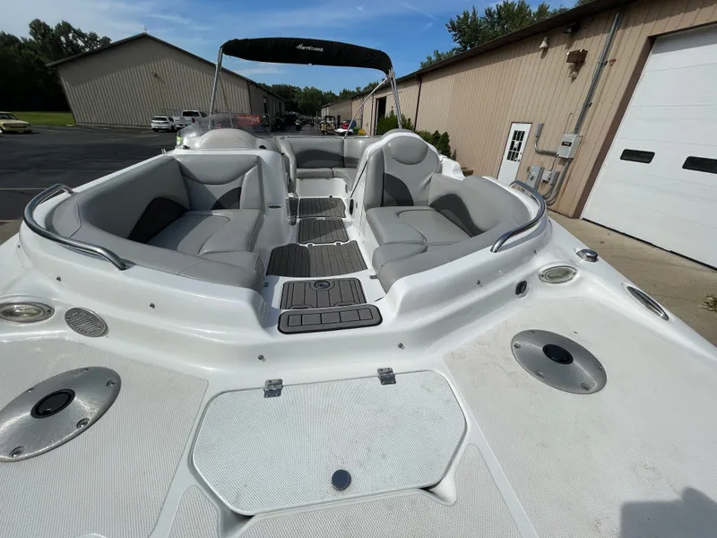 Slide: The Image of The image shows a 2018 Hurricane SS202 boat with gray seating and an open deck. - 11
