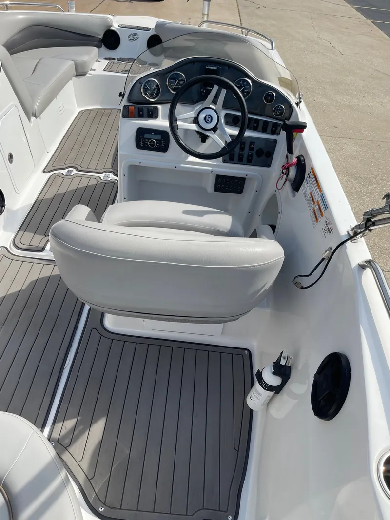 Slide: The Image of The image shows the cockpit of a 2018 Hurricane SS202 boat with gray seats and dashboard. - 16