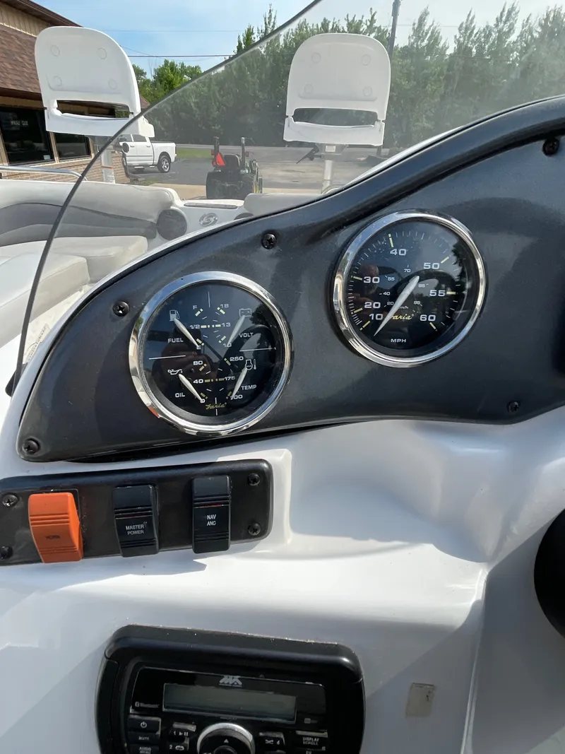 Slide: The Image of The image shows the dashboard of a 2018 Hurricane SS202 boat with gauges and switches. - 22
