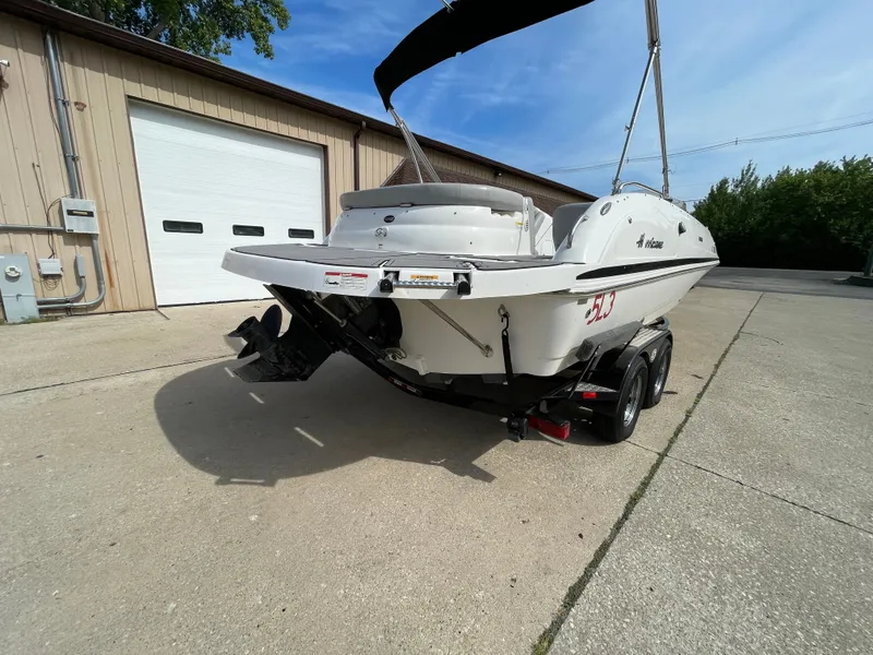 Slide: The Image of A 2018 Hurricane SS202 boat on a trailer in front of a garage. - 3