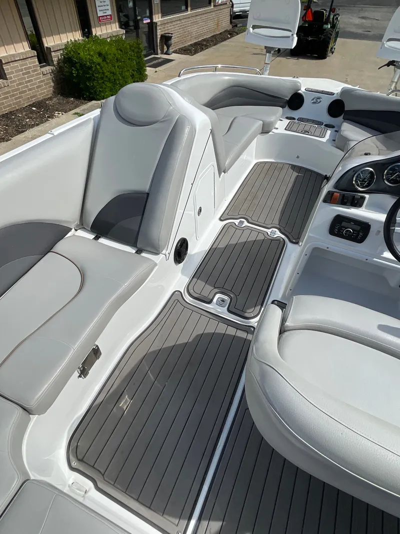 Slide: The Image of The image shows the interior of a 2018 Hurricane SS202 boat with gray seating and flooring. - 18