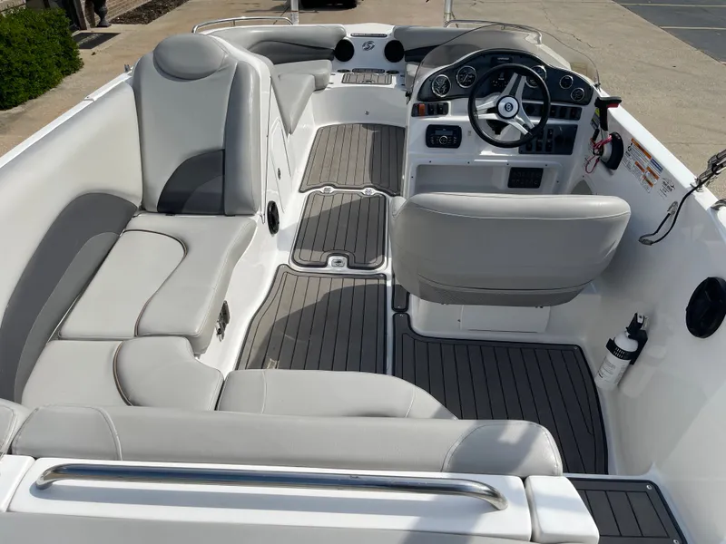 Slide: The Image of The image shows the cockpit of a 2018 Hurricane SS202 boat with gray seating and a modern dashboard. - 15
