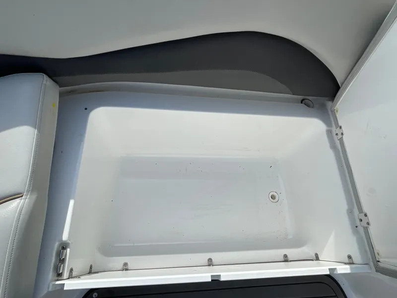 Slide: The Image of An open storage compartment on a boat with a white interior and gray accents. - 30