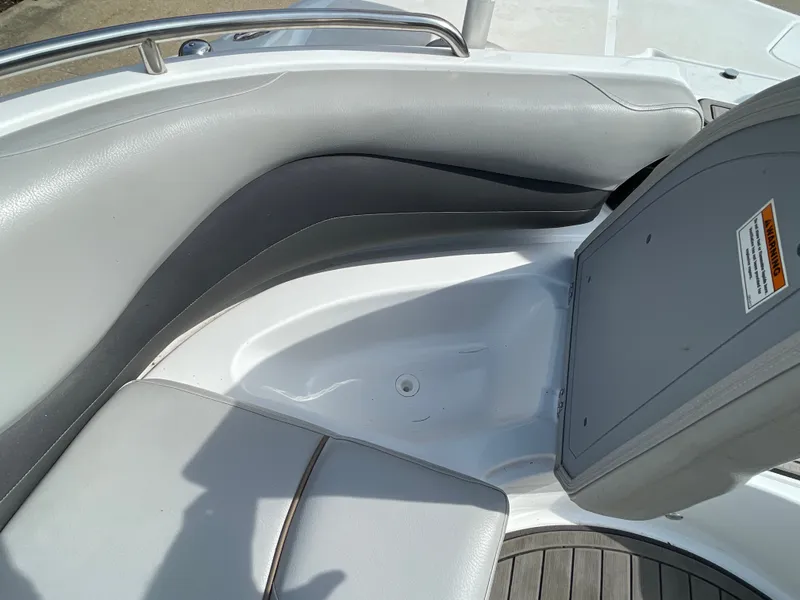 Slide: The Image of The image shows the seating area of a 2018 Hurricane SS202 boat with gray upholstery. - 28