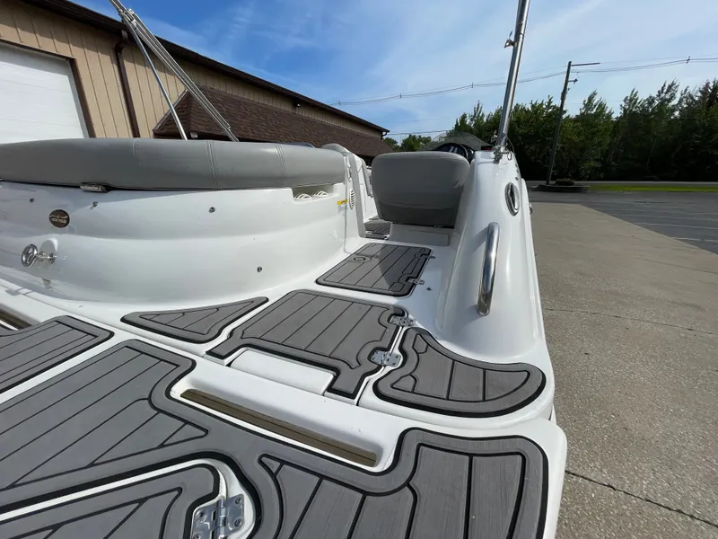 Slide: The Image of The image shows the deck of a 2018 Hurricane SS202 boat with gray upholstery and flooring. - 14